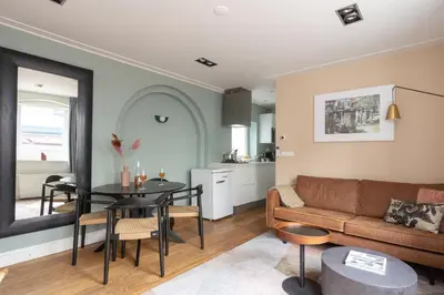 a living room with a couch and a table at Numa Amsterdam Helmers in Amsterdam