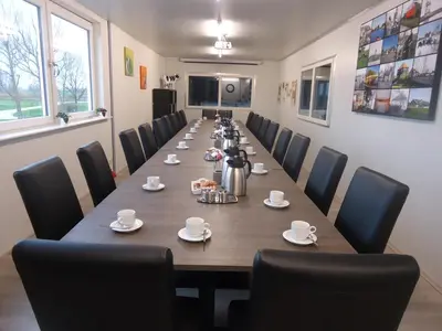 a long conference room with a long table and chairs at Hoeve Meerzicht in Monnickendam