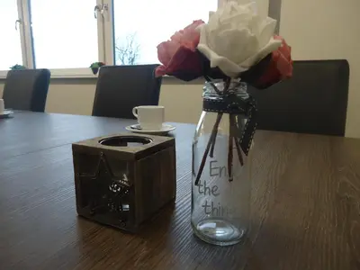 a vase with flowers in it sitting on a table at Hoeve Meerzicht in Monnickendam