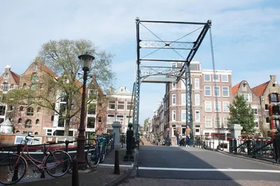 a bridge over a street in a city with buildings at hip & stylish apartment in center, near trainstation, 15 min walk in Amsterdam