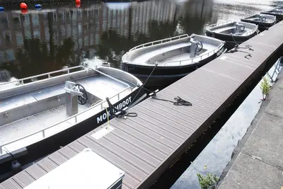 two boats are docked at a dock in the water at hip & stylish apartment in center, near trainstation, 15 min walk in Amsterdam