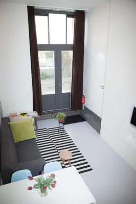 a living room with a couch and a table at hip & stylish apartment in center, near trainstation, 15 min walk in Amsterdam