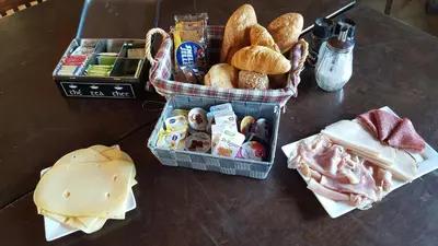 a table with a basket of different types of food at Het Zwanennest in Den Ilp