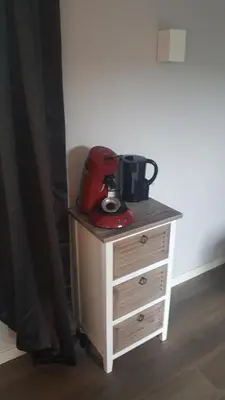 a red appliance sitting on top of a dresser at Het Zwanennest in Den Ilp