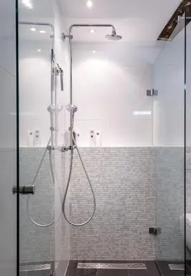 a shower with a glass door in a bathroom at 18th Century Groundfloor Canal House with patio/garden in Amsterdam