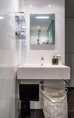 a bathroom with a white sink and a mirror at 18th Century Groundfloor Canal House with patio/garden in Amsterdam