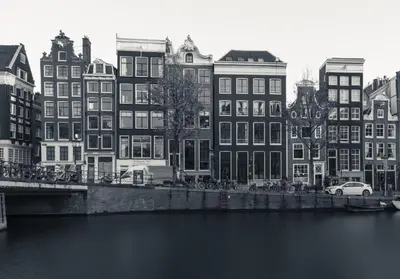 a black and white photo of buildings next to a river at 18th Century Groundfloor Canal House with patio/garden in Amsterdam
