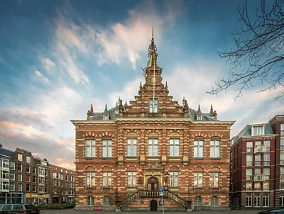 a large building with a tower on top of it at Pestana Amsterdam Riverside in Amsterdam