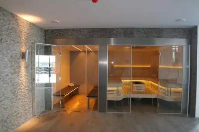 a room with a glass partition with a table at Van Der Valk Hotel Almere in Almere