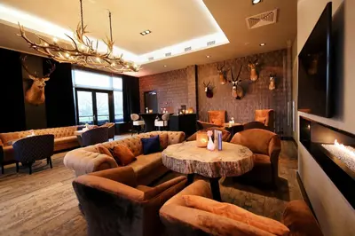 a lobby with couches and a table in a restaurant at Van Der Valk Hotel Almere in Almere