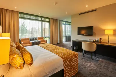 a hotel room with a bed and a desk and a television at Van Der Valk Hotel Almere in Almere