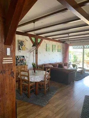 a living room with a table and a couch at B&B De Kaagse Koe in Huigsloot