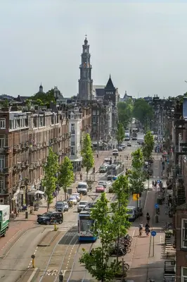 a busy city street with cars and a bus at Hotel Larende in Amsterdam