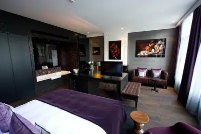 a bedroom with a bed and a desk with a computer at Canal House in Amsterdam