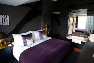 a bedroom with a large bed and a large mirror at Canal House in Amsterdam