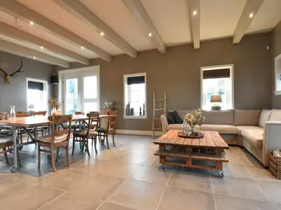 a living room with a couch and a table at Spacious Holiday Home in the Beemster near a Windmill in Middenbeemster