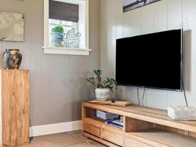 a flat screen tv hanging on a wall in a living room at Holiday Home in Beemster by Windmill in Middenbeemster