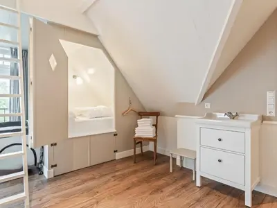 a attic bathroom with a sink and a mirror at Holiday Home in Beemster by Windmill in Middenbeemster