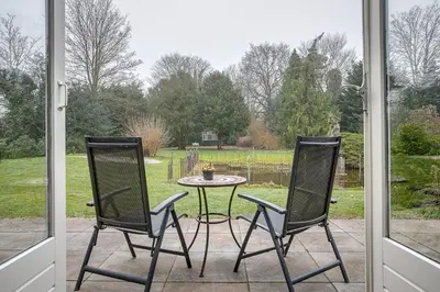 a patio with a table and two chairs and a table at Boutique Hotel 't Vosje in Haarlem