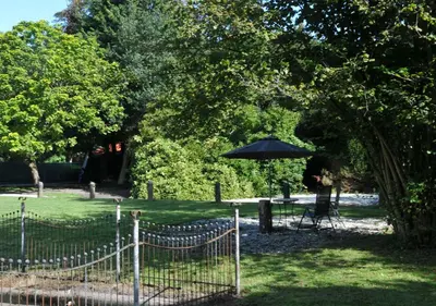 a table and an umbrella in a park at Boutique Hotel 't Vosje in Haarlem