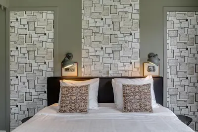 a bedroom with a white bed with two pillows at Boutique Hotel 't Vosje in Haarlem