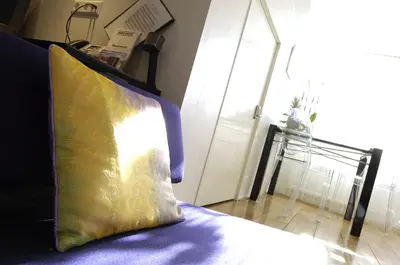a yellow pillow sitting on a bed in a room at Amsterdam Boutique Apartments in Amsterdam
