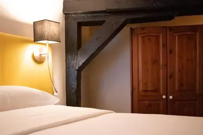 a bedroom with a bed and a wooden door at Hapimag Apartments Amsterdam in Amsterdam