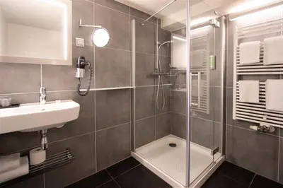 a bathroom with a shower and a sink at Hapimag Apartments Amsterdam in Amsterdam