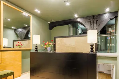 a dining room with a table and a mirror at Hapimag Apartments Amsterdam in Amsterdam