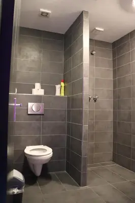 a bathroom with a toilet and a shower at Amsterdam Hostel Leidseplein in Amsterdam