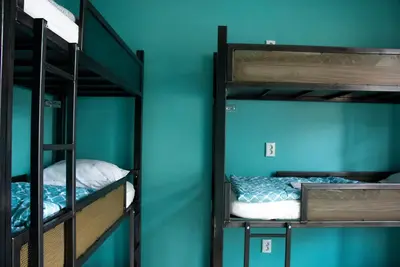 two bunk beds in a room with a blue wall at Amsterdam Hostel Leidseplein in Amsterdam