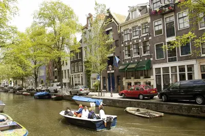 a group of people in a boat on a canal at Rembrandtplein Hotel in Amsterdam