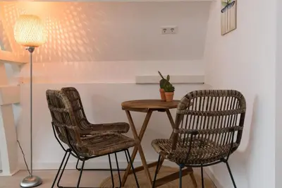 two chairs and a table and a lamp in a room at Way Up Studio in Amsterdam
