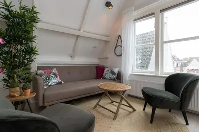 a living room with a couch and a table at Way Up Studio in Amsterdam