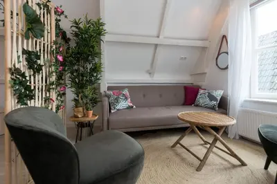 a living room with a couch and a table at Way Up Studio in Amsterdam