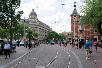 a busy city street with people walking on the street at Way Up Studio in Amsterdam