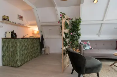 a living room with a couch and a table at Way Up Studio in Amsterdam