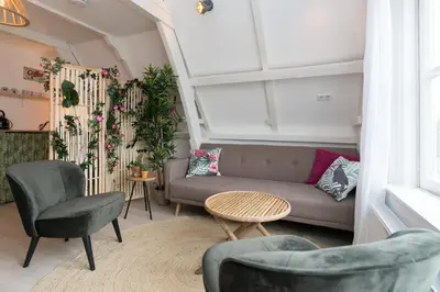 a living room with a couch and chairs at Way Up Studio in Amsterdam