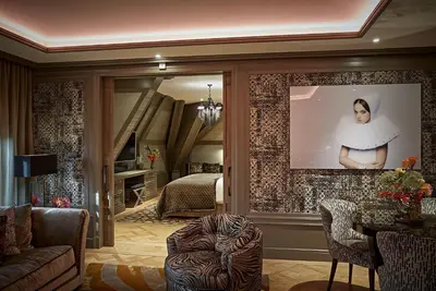 a living room with a large mirror and a bedroom at Hotel TwentySeven - Small Luxury Hotels of the World in Amsterdam