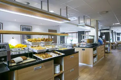 a buffet line with many different types of food at Holiday Inn Express Amsterdam - Schiphol by IHG in Hoofddorp