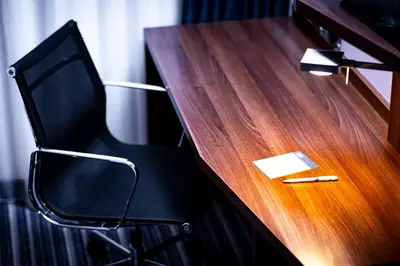 a black chair sitting next to a wooden desk at Holiday Inn Express Amsterdam - Schiphol by IHG in Hoofddorp