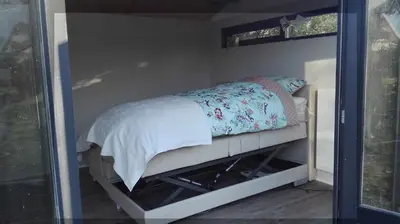 a small bed in a room with a window at De Zes Wielen in Alkmaar