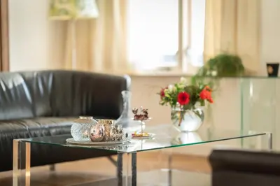 a glass coffee table in a living room with a couch at Huize Mare Appartementen in Bergen aan Zee