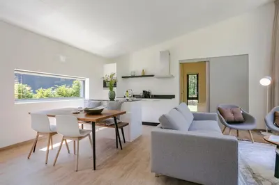 a living room with a couch and a table at Dutchen Suitelodges Gooilanden in Loosdrecht
