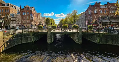 a bridge over a river in a city with buildings at Your a Royalty - Equal Design by JoyJoyJoy - Top Floor and Top Views - Creating houses for the poor in Amsterdam