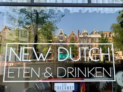 a window with a sign that says new office cleaners and drinks at Jordan Canal Studio in Amsterdam