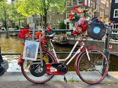 a red bike parked in front of a canal at Jordan Canal Studio in Amsterdam