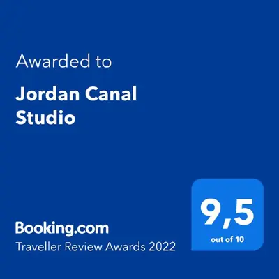 a blue sign with the text awarded to jordan canadian studio at Jordan Canal Studio in Amsterdam