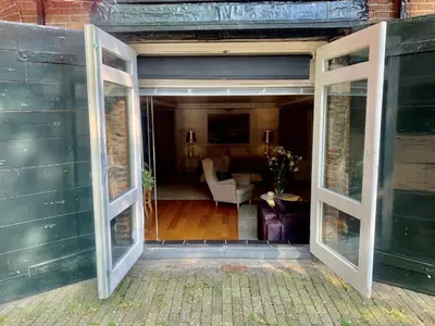 an open door to a room with a living room at Jordan Canal Studio in Amsterdam