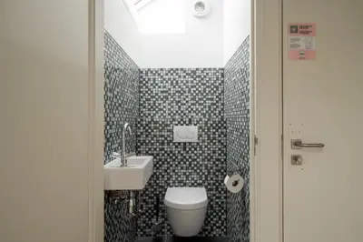 a bathroom with a toilet and a sink at Numa Amsterdam Oosterpark in Amsterdam